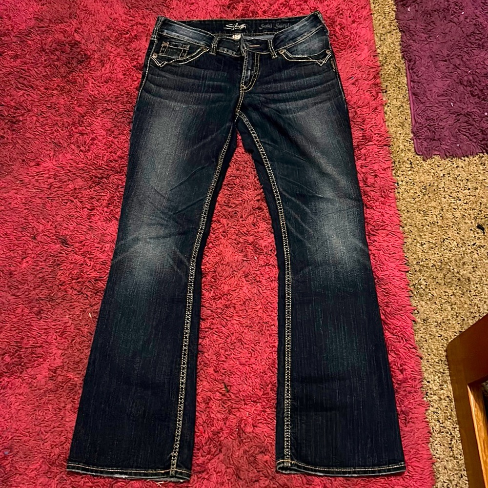 Size 30/32 silver SUKI SURPLUS flare leg jeans with slight fade